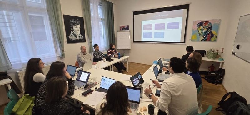 The partners following the project overview on the screen