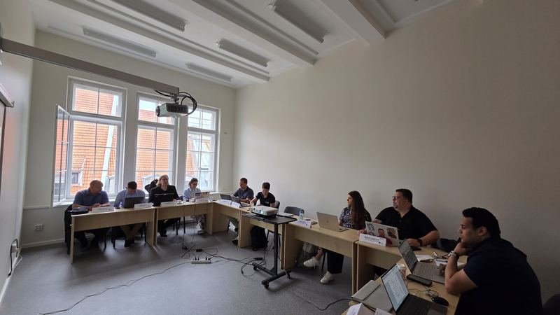 The partners at the tables during the meeting